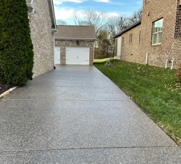 A curved sidewalk runs through a residential neighborhood with houses on both sides. (1)